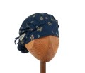 Bawełniany kolorowy czepek  medyczny na długie włosy, damski KOALA  w jaskółki na granatowym tle. Widok z przodu - związany.